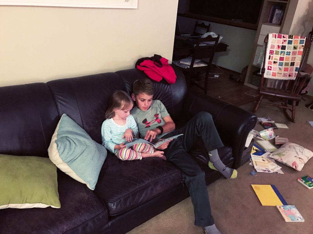 Andrew (just 13) reading to Lucia (4, tomorrow).